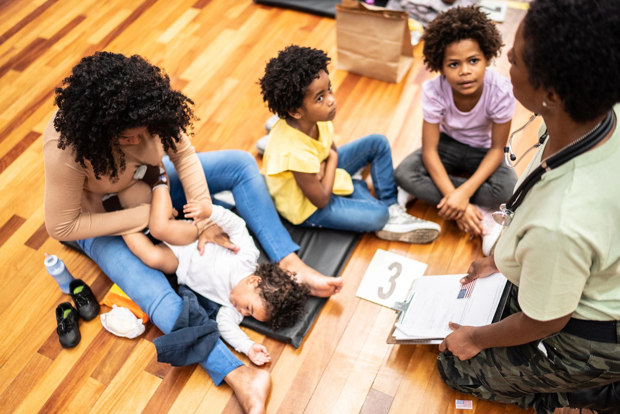 Adult helping children work through clues together