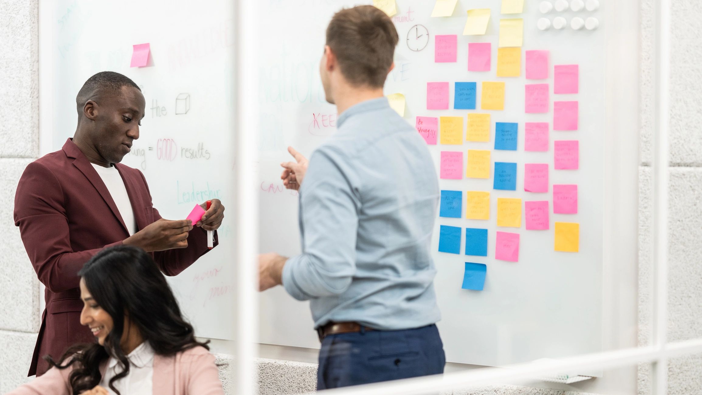 Team brainstorming ideas with sticky notes on a planning board