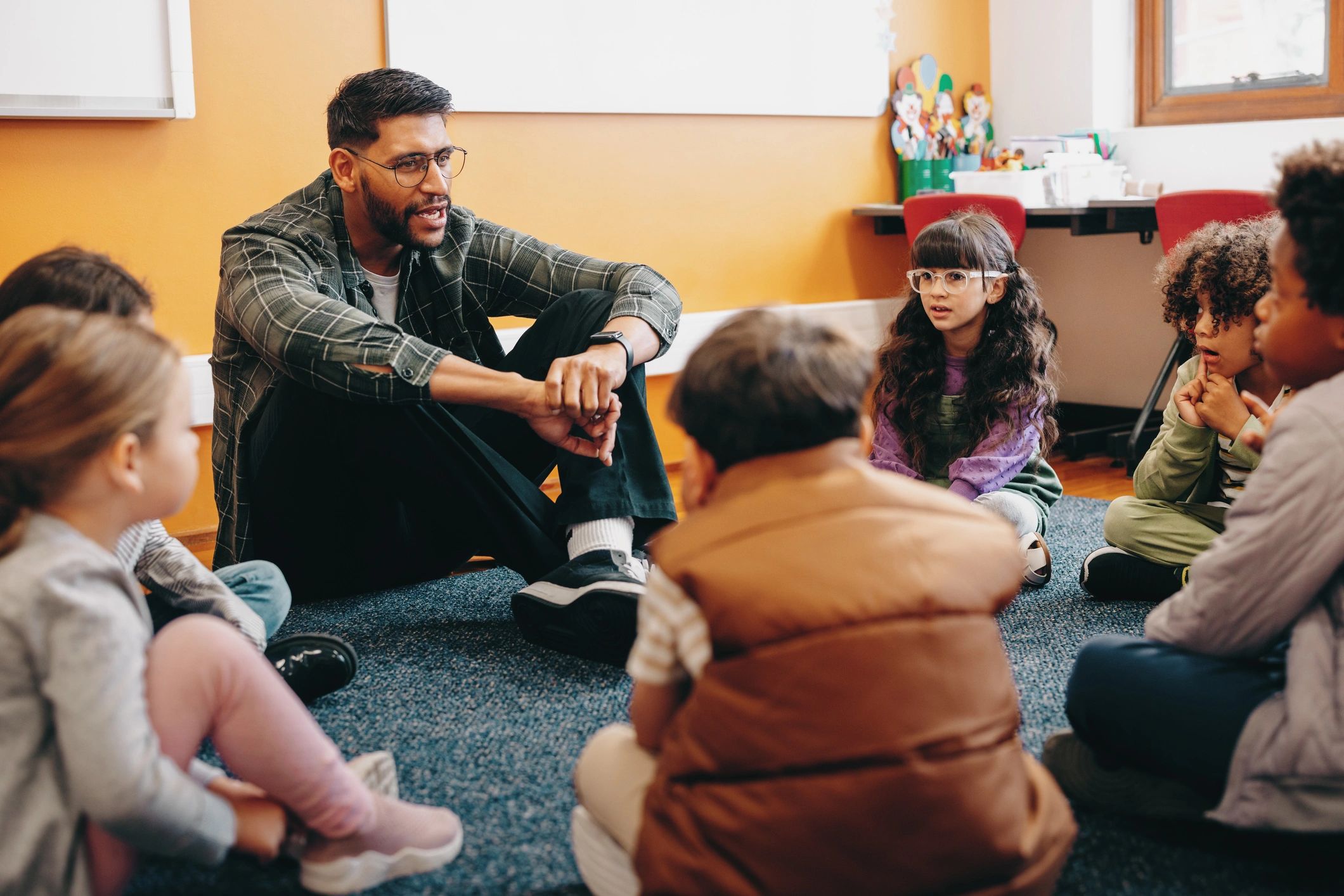 Teacher leading children through a group mystery activity