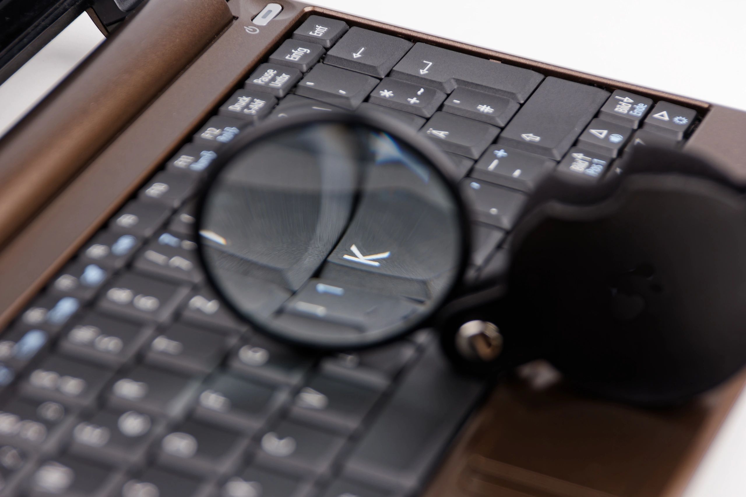 Laptop with magnifying glass representing modern puzzle solving