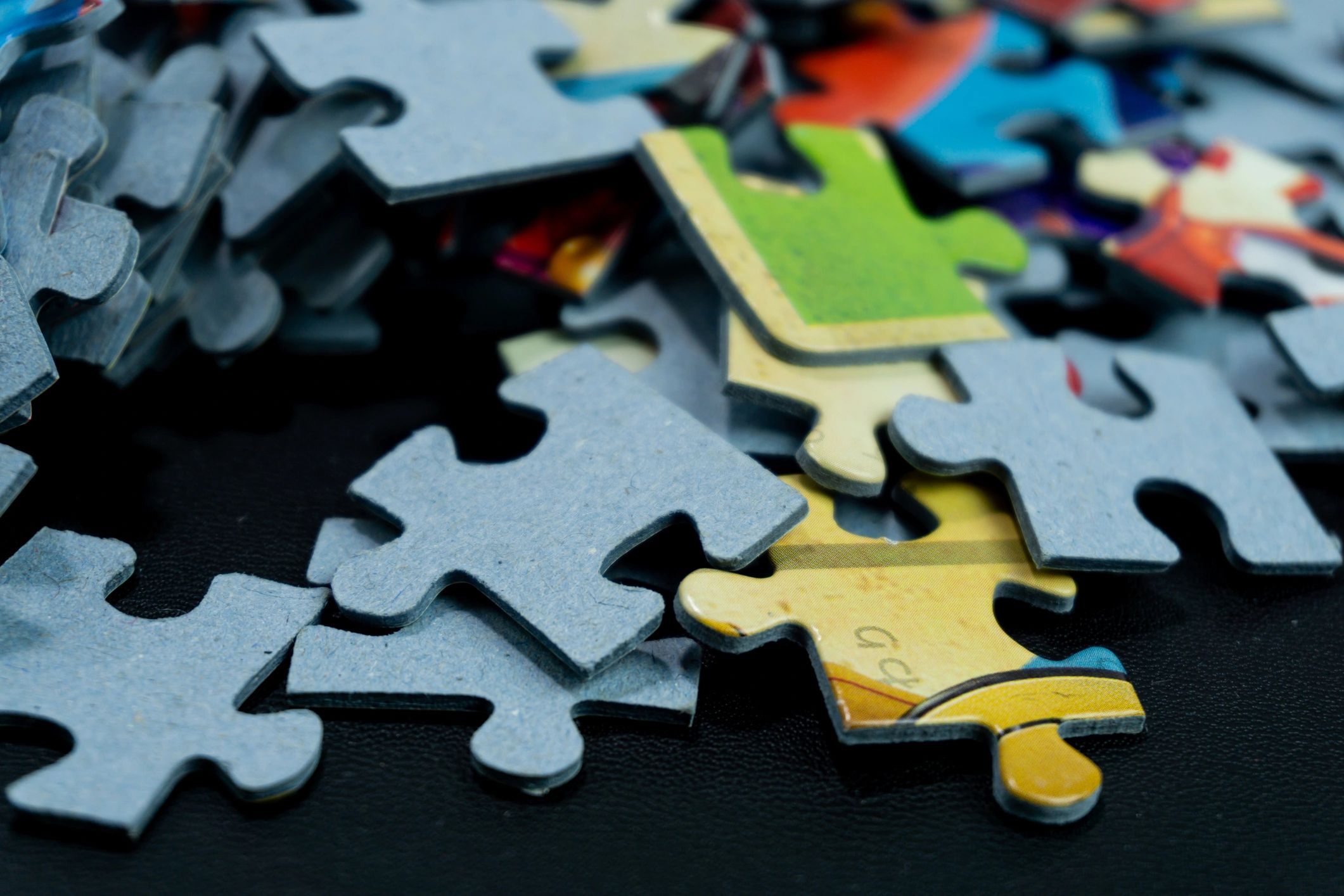 Puzzle pieces on dark background suggesting printable puzzle kit design