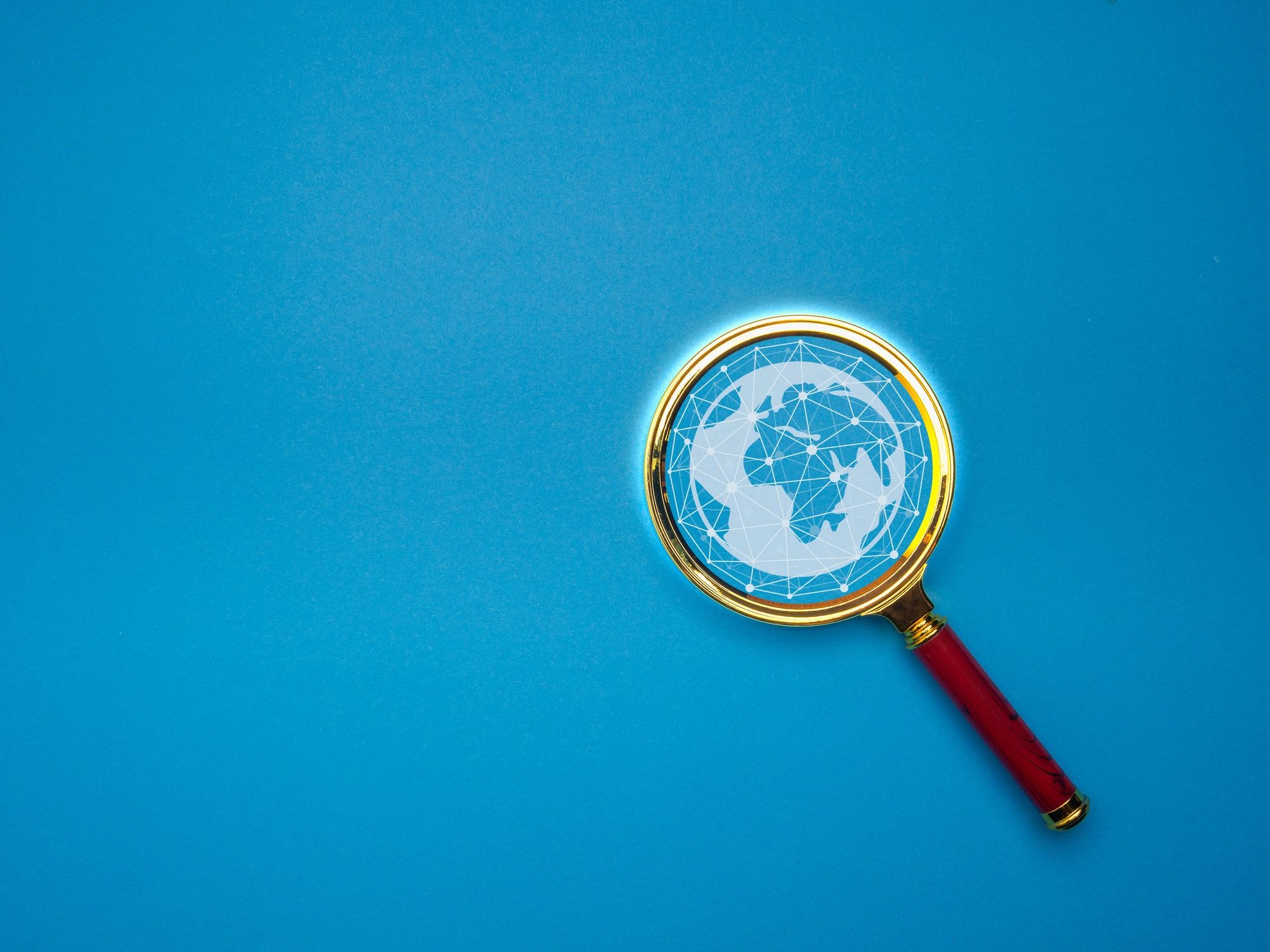 Blue magnifying glass and globe image representing deeper puzzle discovery