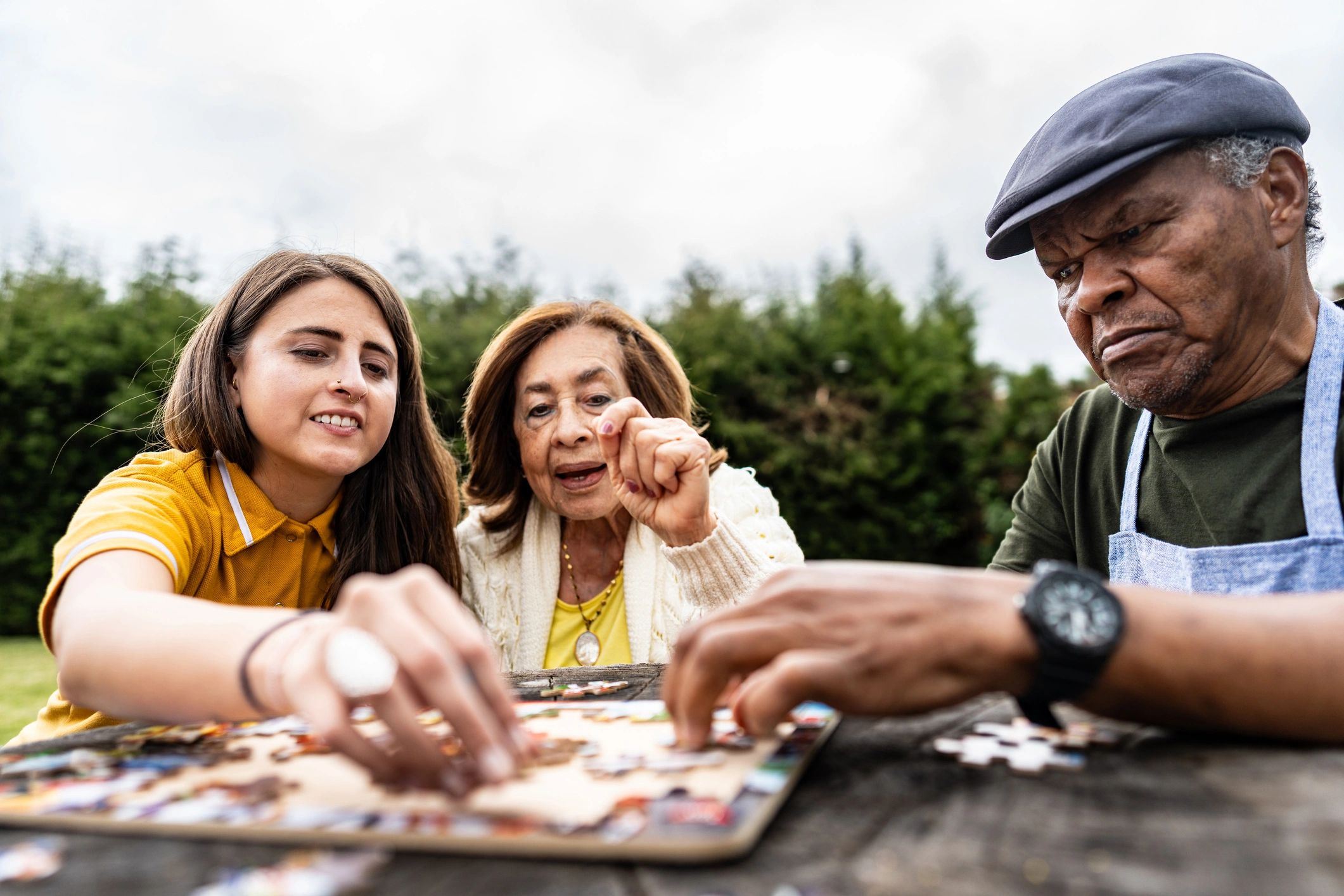 Family solving a puzzle together outdoors
