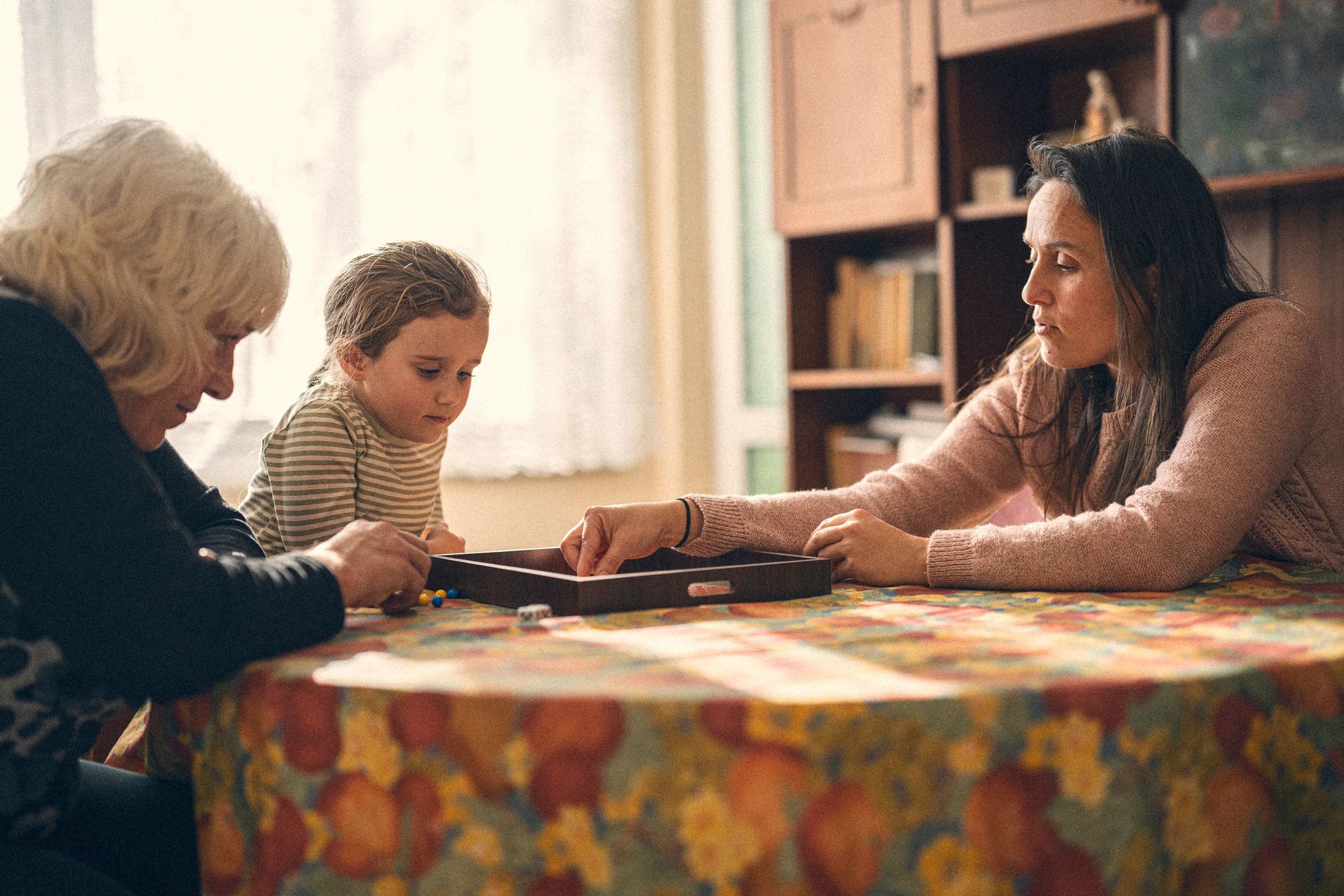 Family playing a mystery-style game together at home