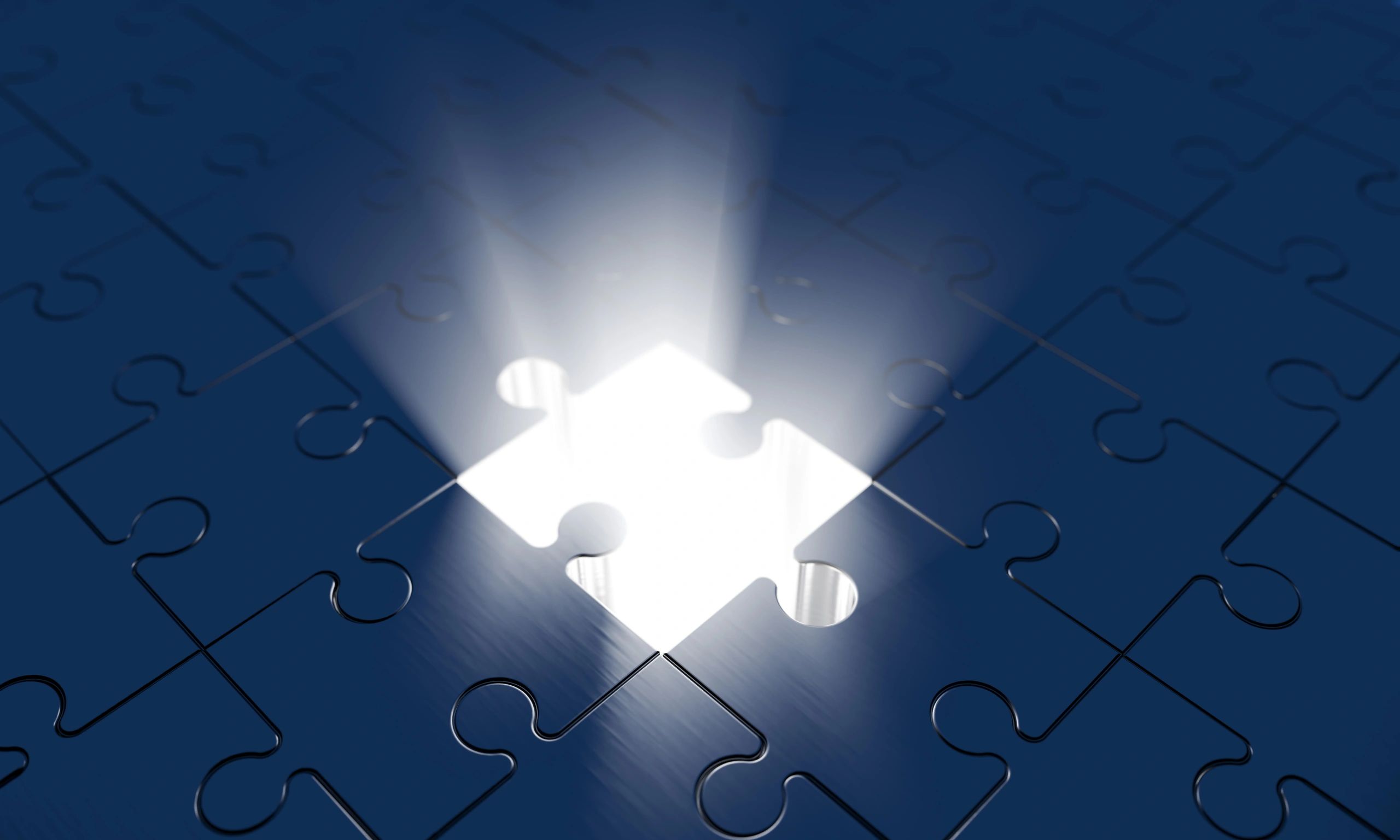 Nearly completed jigsaw puzzle with one glowing piece