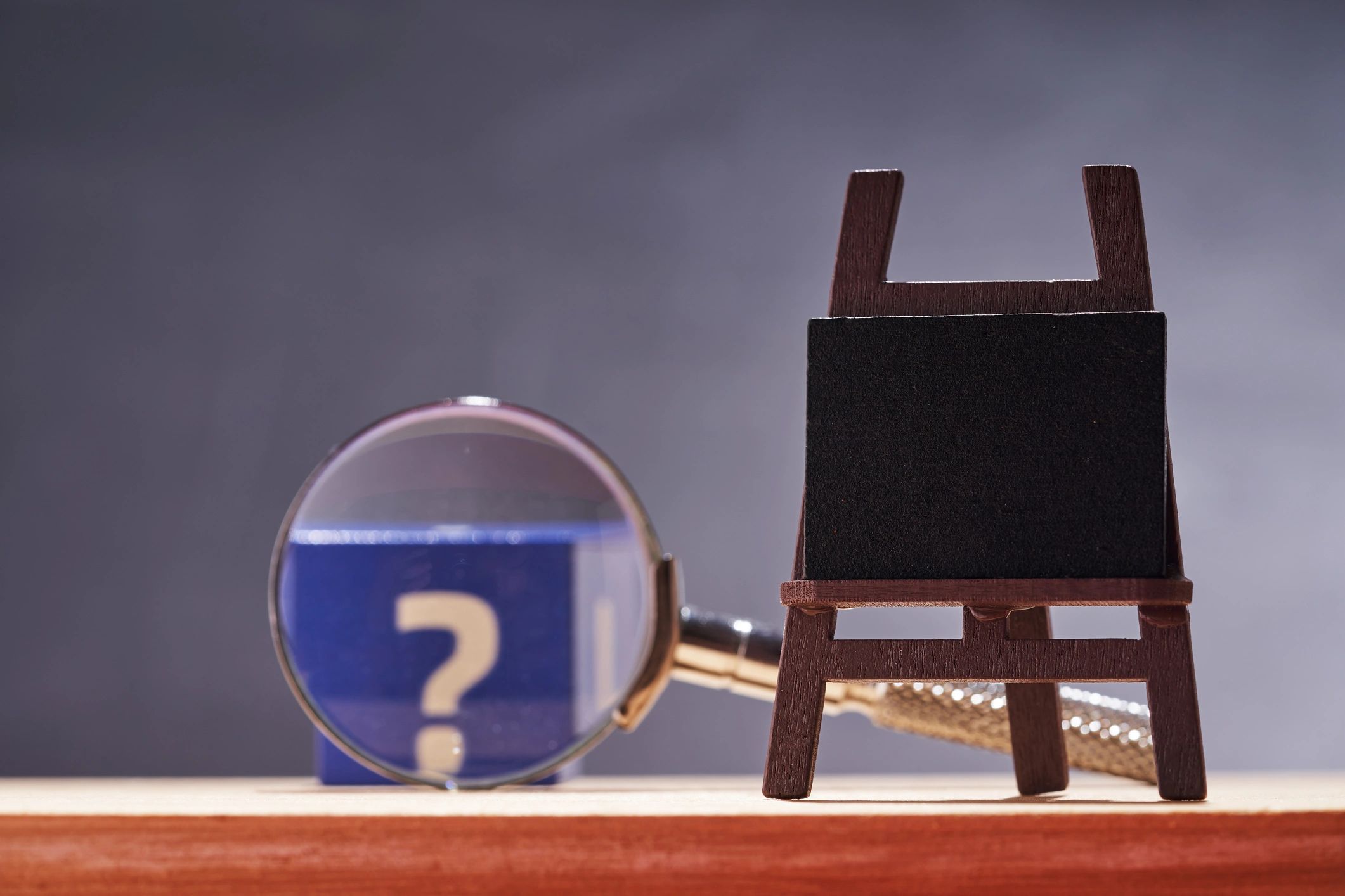 Question mark chalkboard and magnifying glass for featured puzzle section