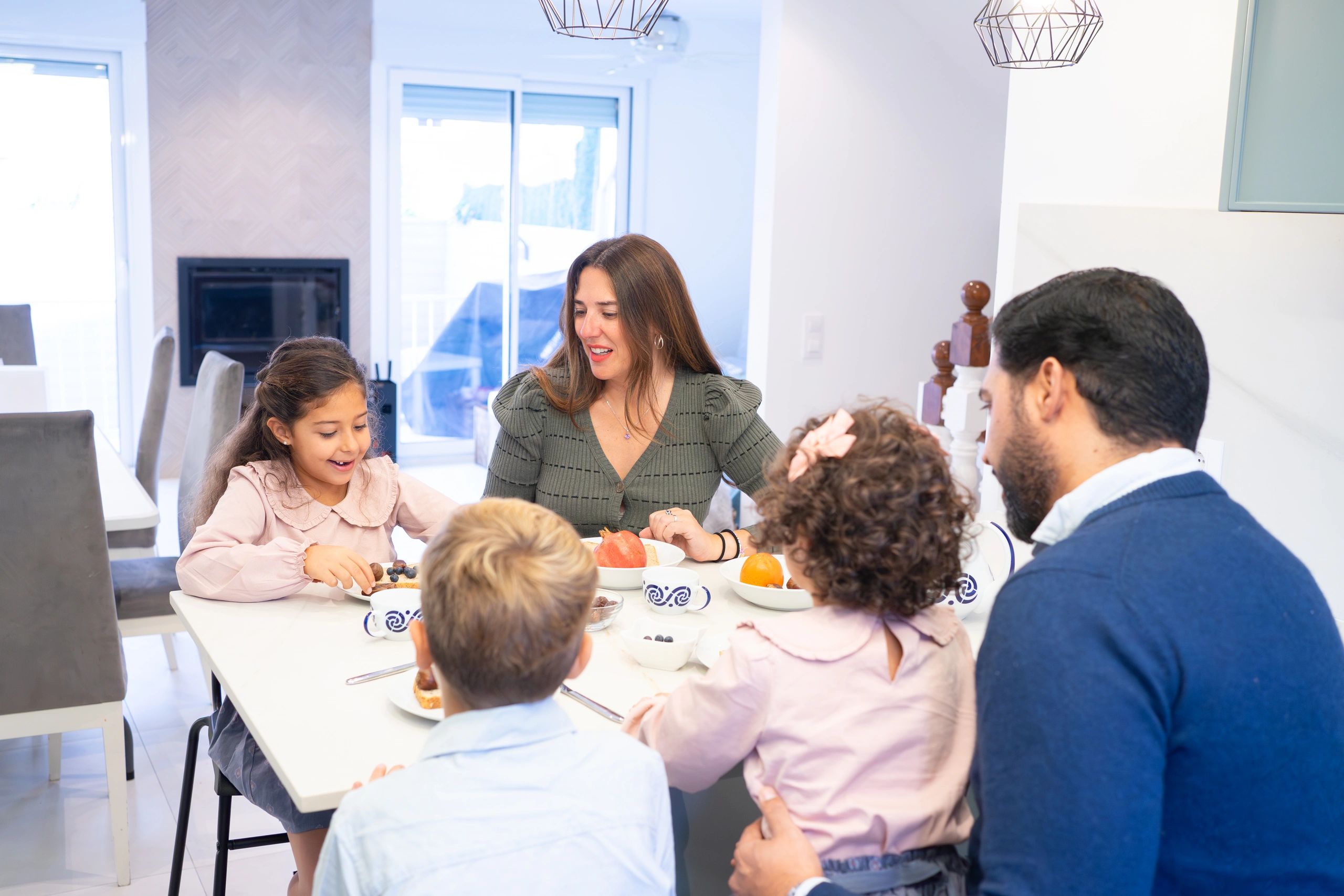 Family gathered at a table for a playful home activity
