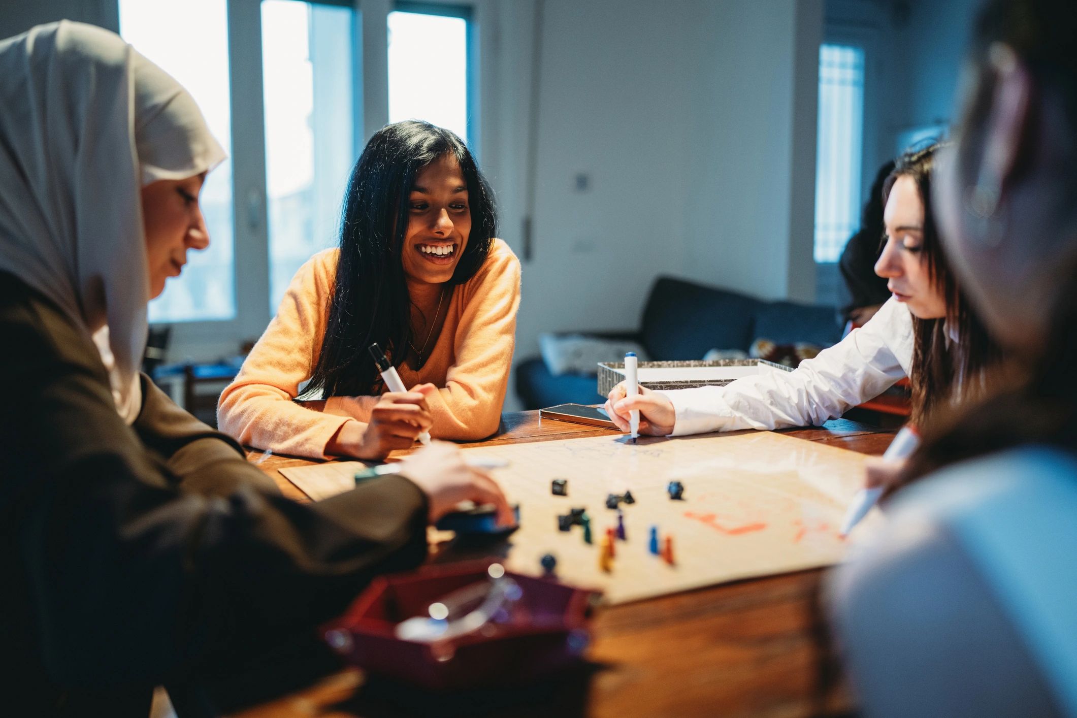 Friends gathered around a table playing a puzzle game together