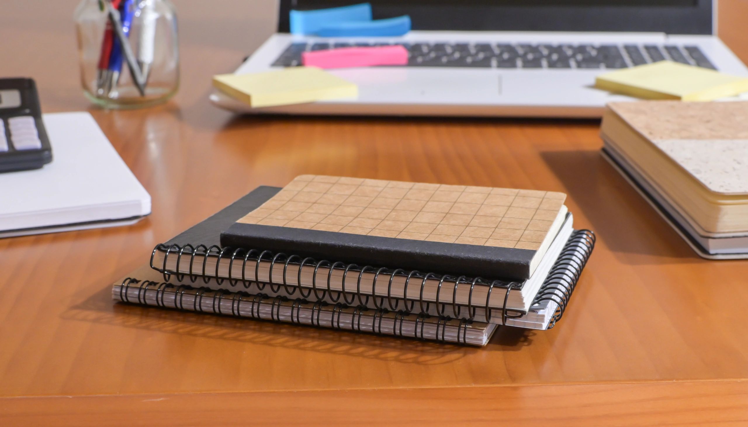 Organized desk with notebooks and clues for puzzle solving