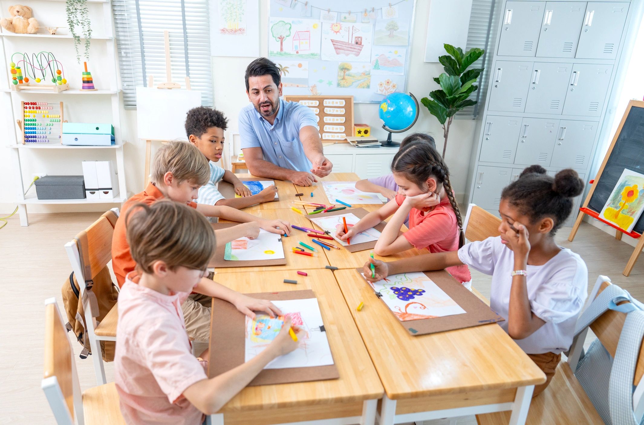 Teacher guiding children during a collaborative classroom activity