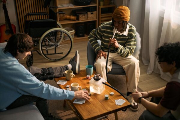 Teenagers with Disability Playing Cards during Social Gathering