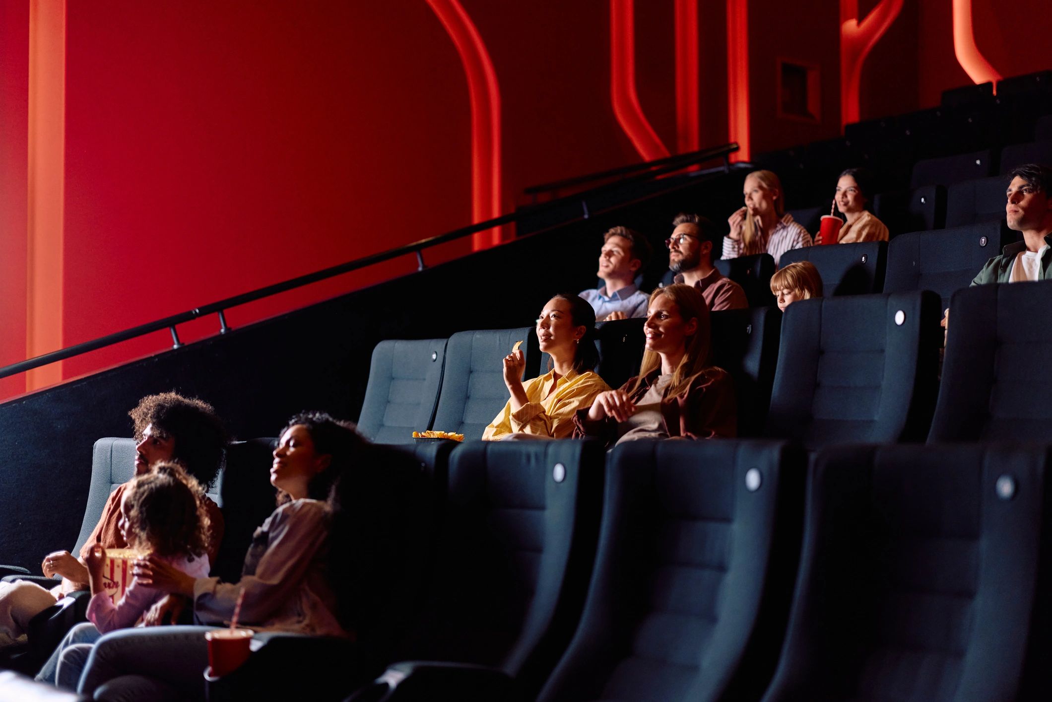 Moviegoers watching a film in a modern cinema